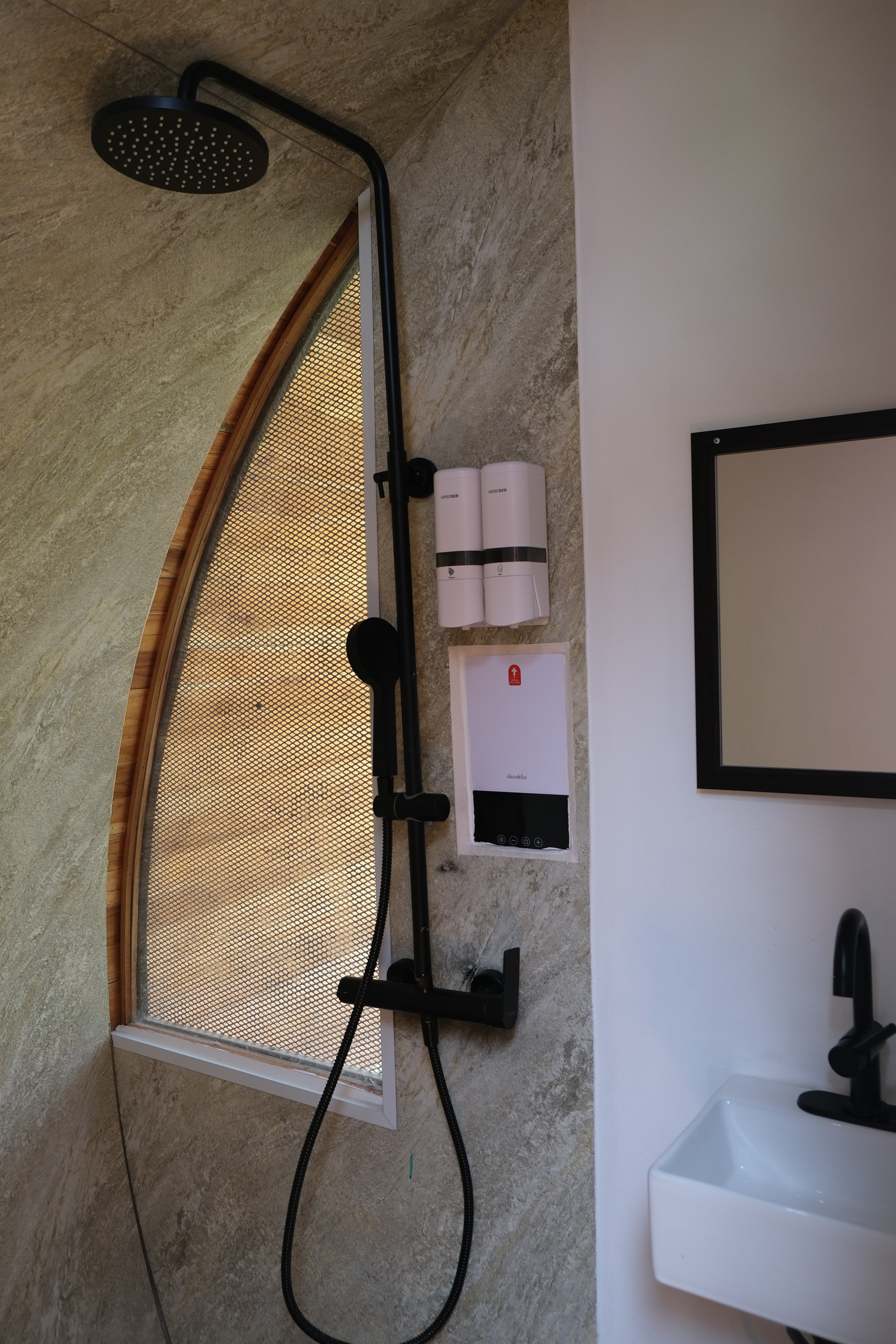 A casita's shower and sink in warm wood