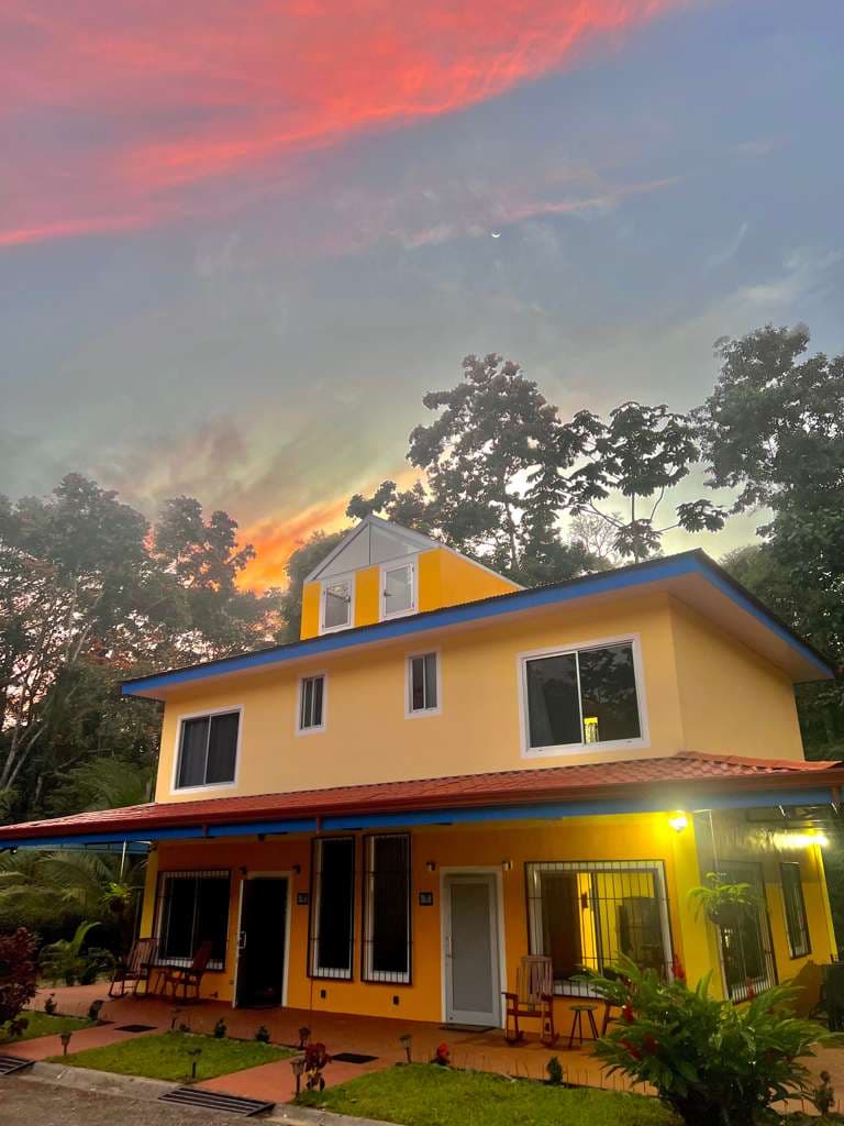 The villa under a pink evening sky